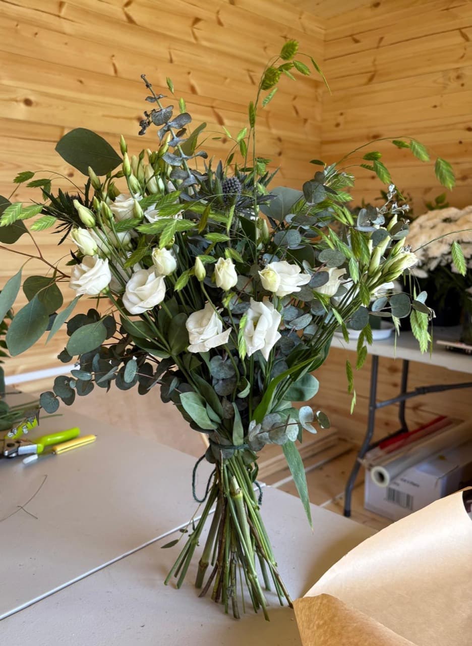 A hand-tied white bouquet with green eucalyptus